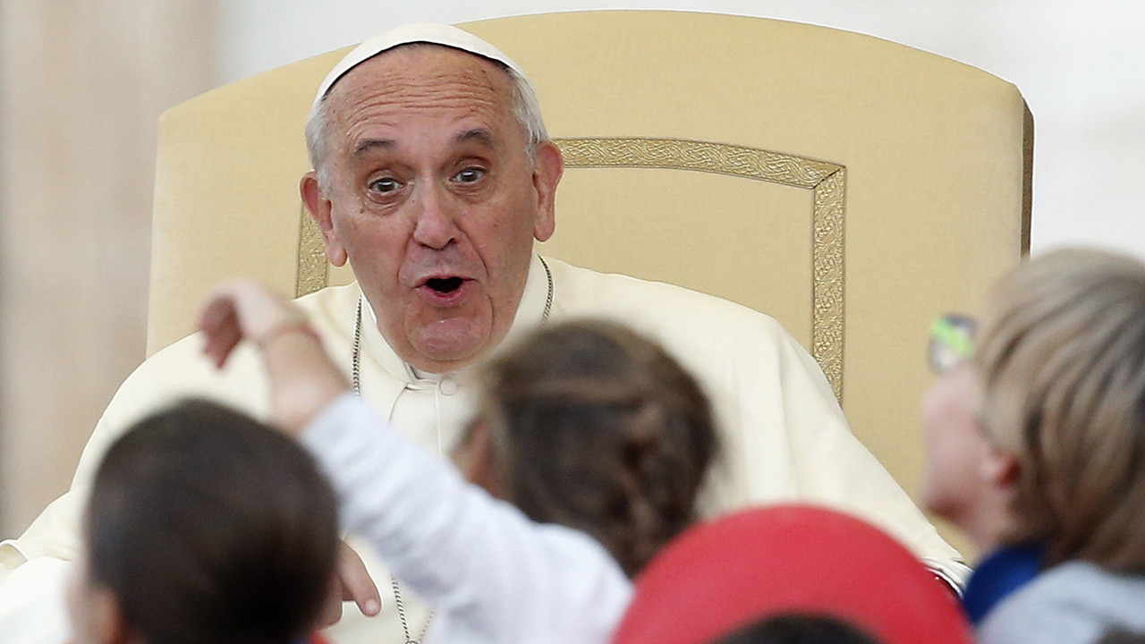 Pope Francis reacts as he leads a special audience with families at St. Peter Square in Vatican