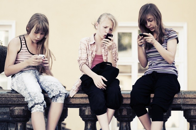 Teenage girls calling on the cell phones